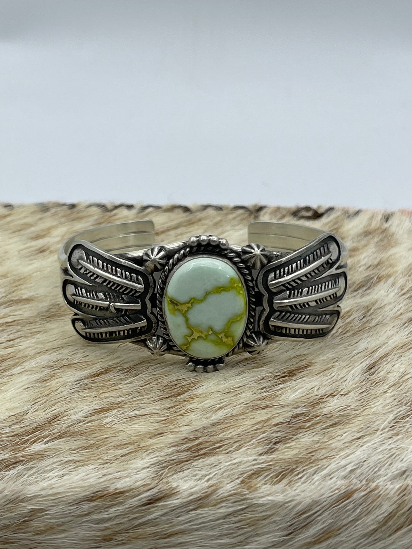 5 3/4"-7 3/4" Palomino Cuff with Feather by Daniel Benally, Navajo (Matrix Varies)