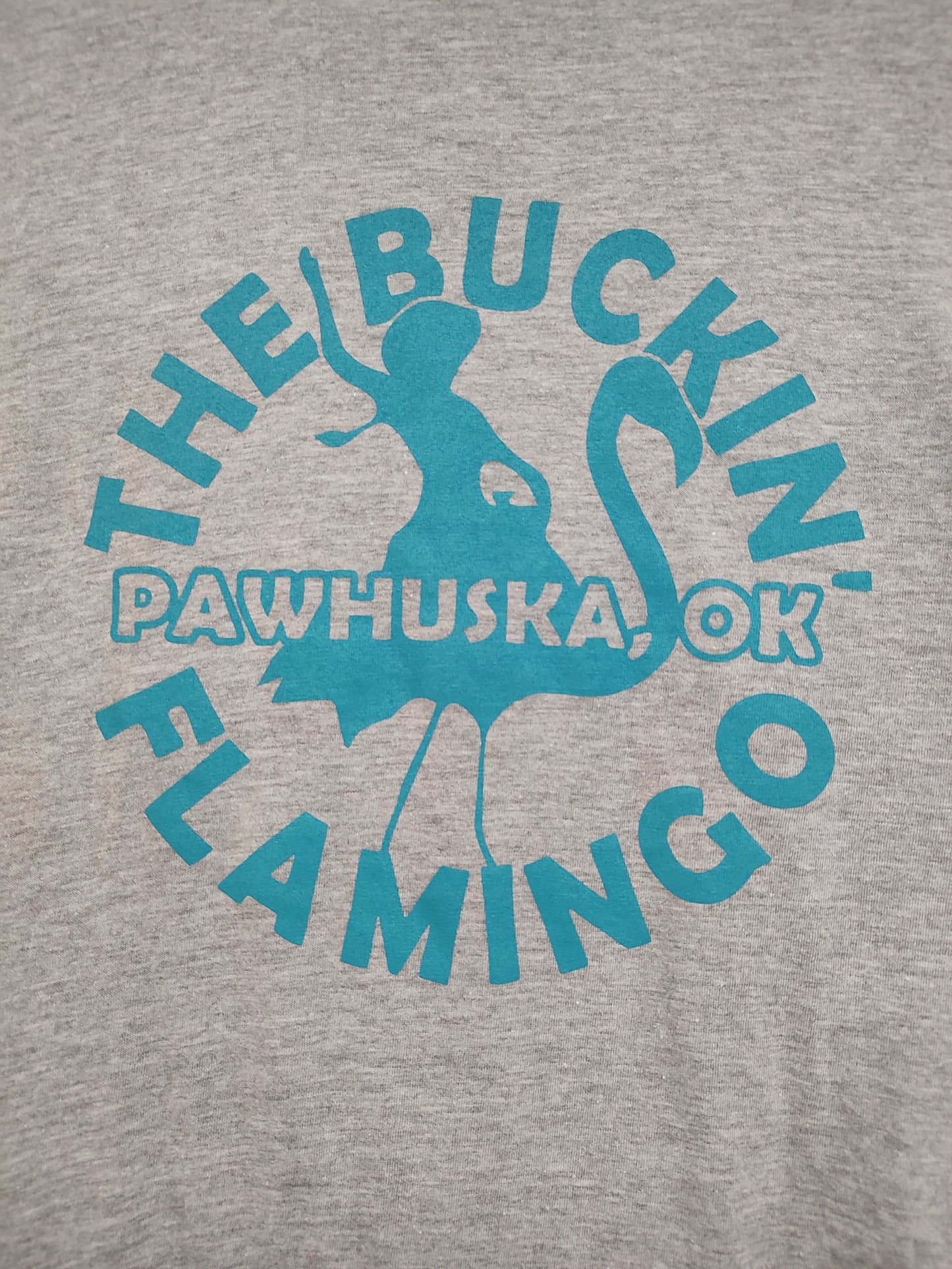 Turquoise Buckin' Flamingo Logo on a Grey Shirt