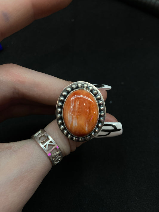 7.0 Orange Spiny Oyster Shell Ring by Calvin Delgarito, Navajo