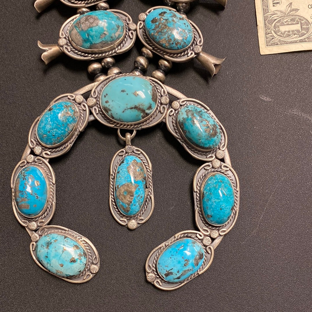 Native American made squash blossom turquoise necklace by Gilbert Nez