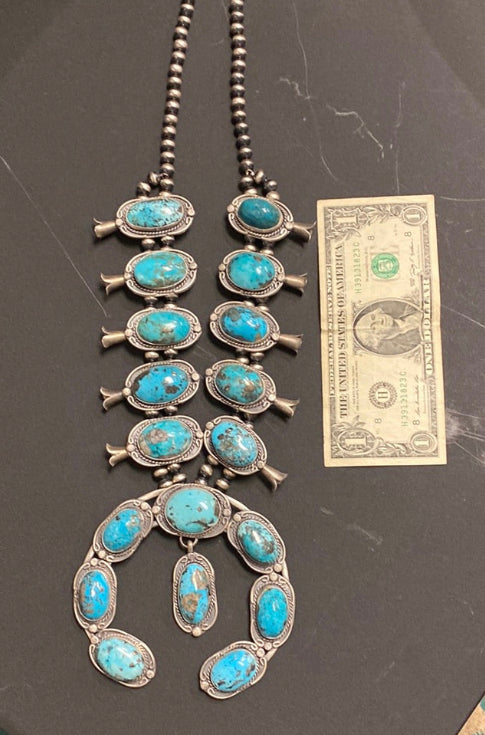 Native American made squash blossom turquoise necklace by Gilbert Nez